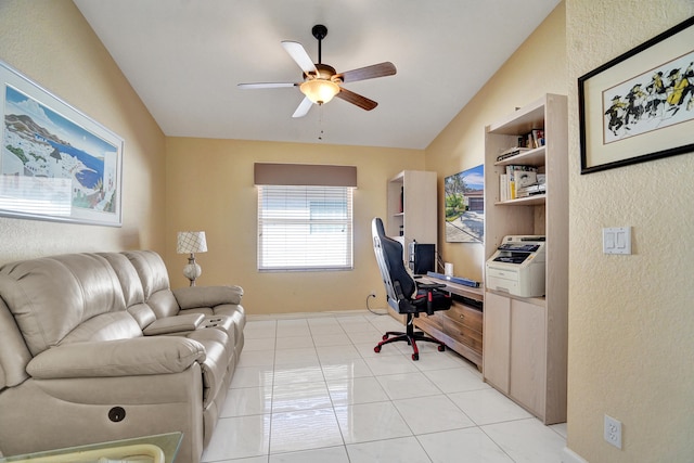 tiled office space with ceiling fan and vaulted ceiling