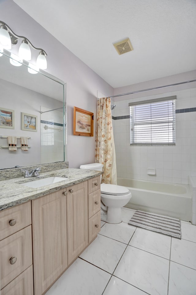 full bathroom with vanity, shower / tub combo with curtain, and toilet