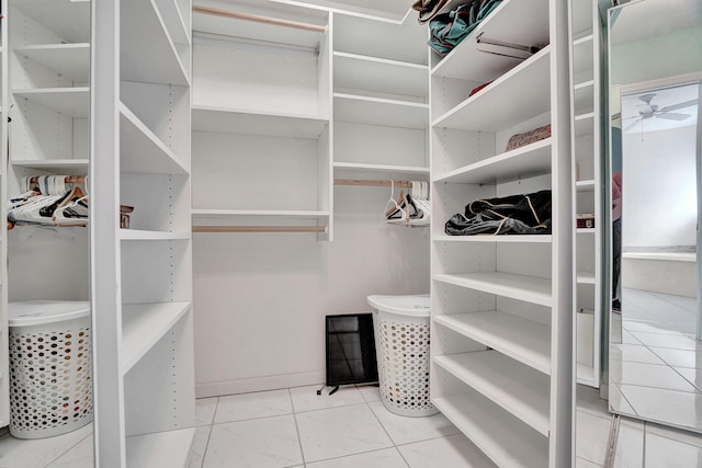 walk in closet featuring tile patterned floors and ceiling fan