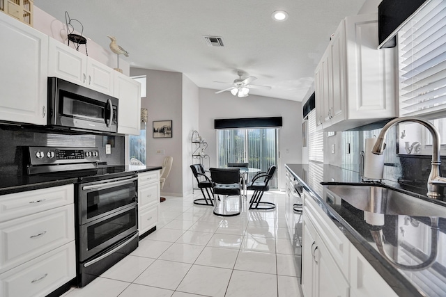 kitchen featuring backsplash, stainless steel appliances, sink, and white cabinets