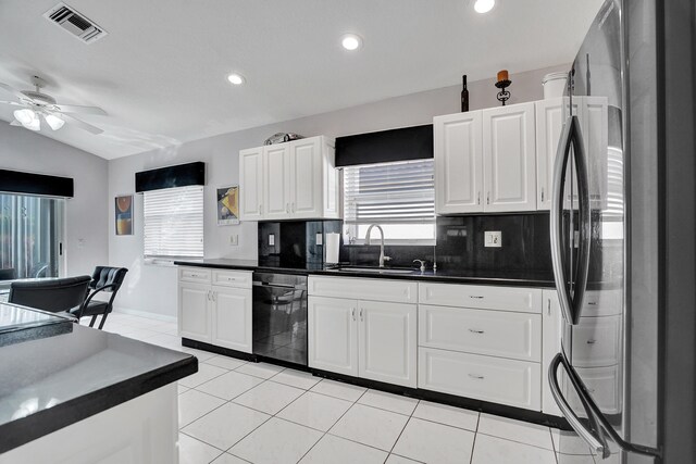 kitchen featuring appliances with stainless steel finishes, sink, white cabinets, backsplash, and light tile patterned floors