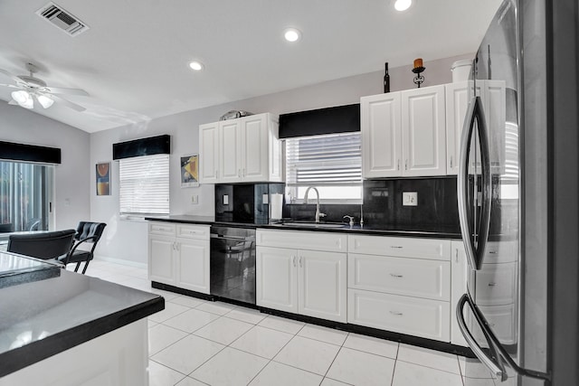 kitchen featuring white cabinetry, black dishwasher, sink, and stainless steel refrigerator