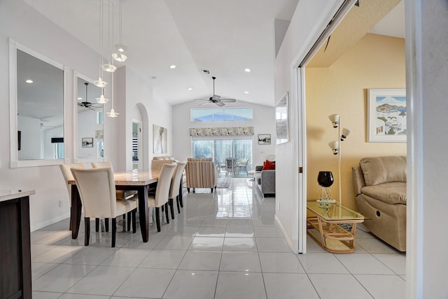 tiled dining area with high vaulted ceiling and ceiling fan