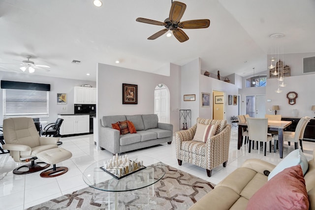 tiled living room featuring lofted ceiling and ceiling fan