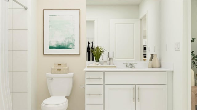 bathroom with vanity, a shower, and toilet