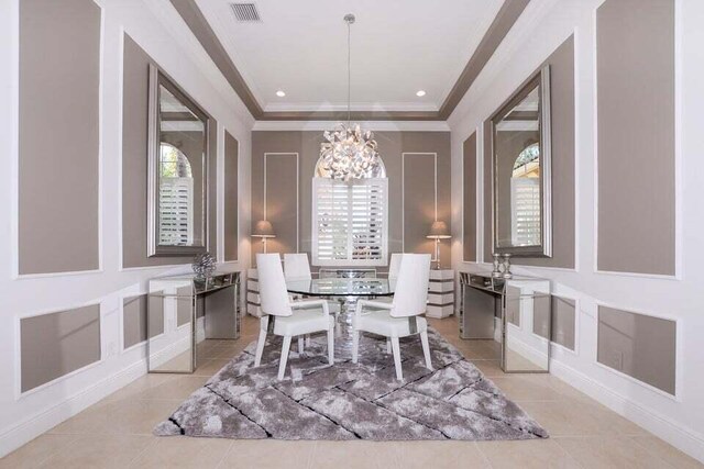 9895 SW Nuova Way, Port Saint Lucie, FL 34986 - dining space with crown molding, light tile patterned floors, a chandelier, and a tray ceiling