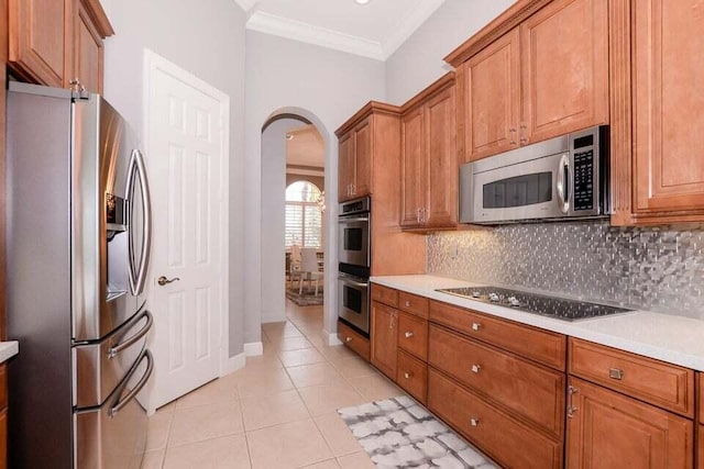9895 SW Nuova Way, Port Saint Lucie, FL 34986 - kitchen with ornamental molding, appliances with stainless steel finishes, light tile patterned floors, and decorative backsplash