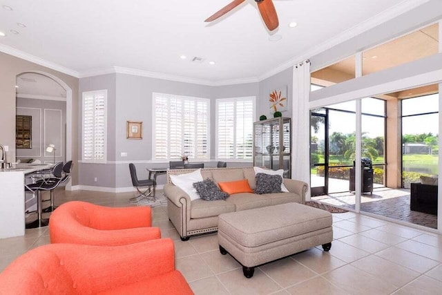 9895 SW Nuova Way, Port Saint Lucie, FL 34986 - tiled living room featuring ceiling fan, ornamental molding, and a healthy amount of sunlight