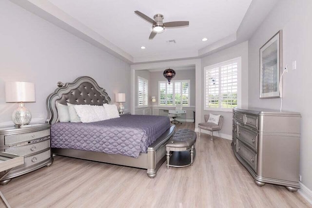 9895 SW Nuova Way, Port Saint Lucie, FL 34986 - bedroom featuring ceiling fan, a raised ceiling, and light hardwood / wood-style floors