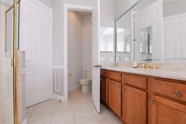 9895 SW Nuova Way, Port Saint Lucie, FL 34986 - bathroom with tile patterned flooring, vanity, walk in shower, and toilet