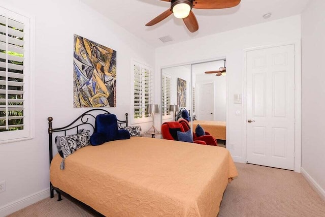 9895 SW Nuova Way, Port Saint Lucie, FL 34986 - bedroom featuring multiple windows, light colored carpet, a closet, and ceiling fan
