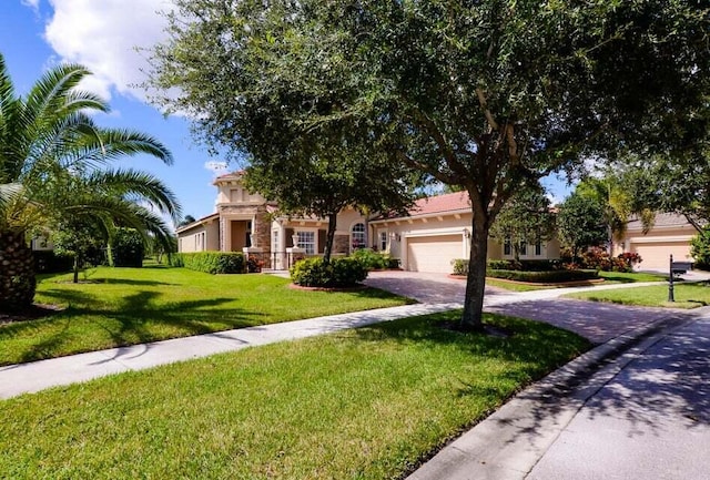 9895 SW Nuova Way, Port Saint Lucie, FL 34986 - view of front facade with a garage and a front lawn