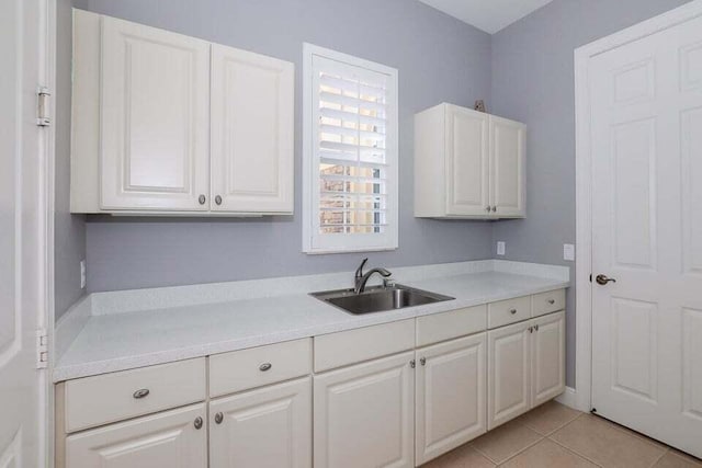 9895 SW Nuova Way, Port Saint Lucie, FL 34986 - kitchen with sink, light tile patterned floors, and white cabinets