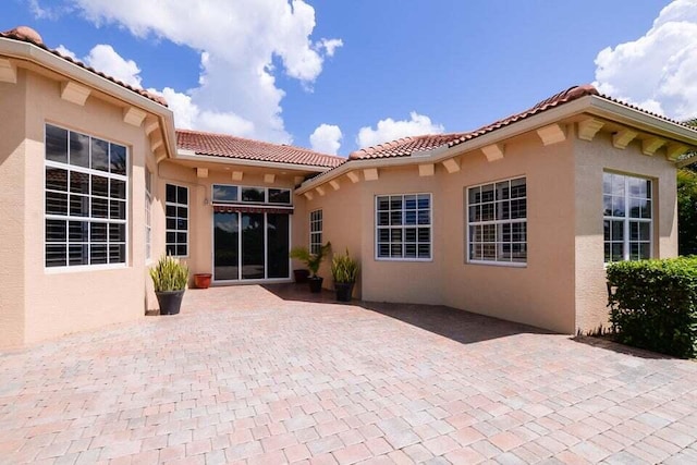 9895 SW Nuova Way, Port Saint Lucie, FL 34986 - rear view of house with a patio