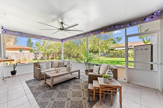 sunroom featuring track lighting, outdoor lounge area, and a ceiling fan