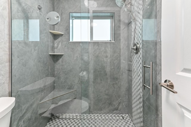 bathroom featuring walk in shower and toilet