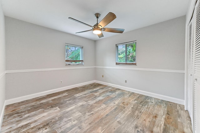 spare room with hardwood / wood-style flooring, plenty of natural light, and ceiling fan