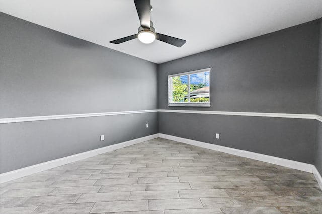 empty room with baseboards and ceiling fan