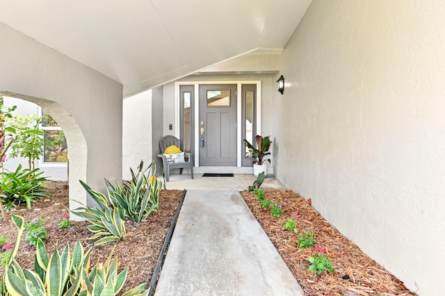 entrance to property with stucco siding