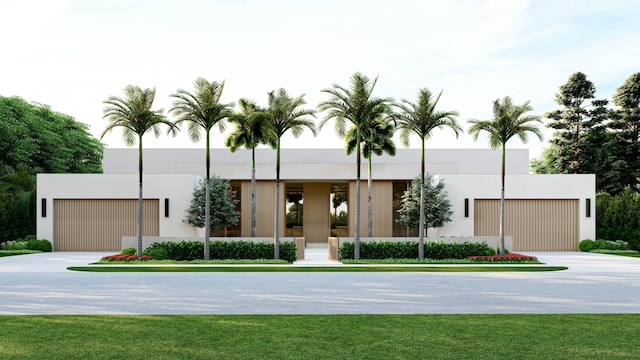 modern home featuring a front lawn, driveway, and stucco siding