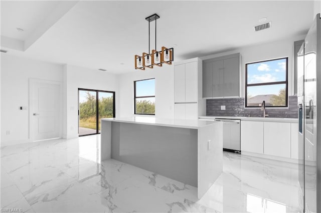 kitchen with white cabinetry, a kitchen island, and modern cabinets