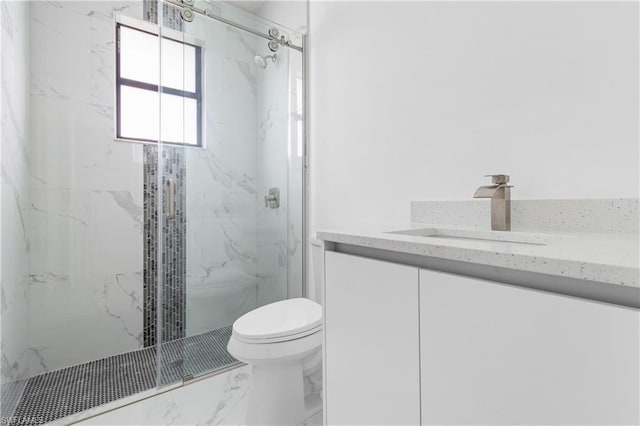 full bath featuring toilet, marble finish floor, a marble finish shower, and vanity