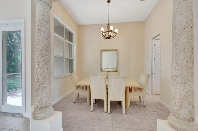 dining space featuring light tile patterned floors, a chandelier, and ornate columns