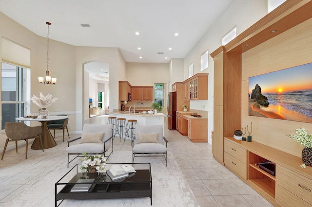 living room featuring visible vents, an inviting chandelier, a high ceiling, light tile patterned flooring, and recessed lighting