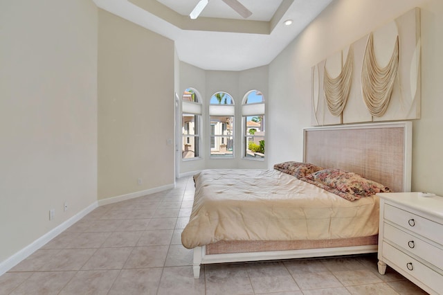 bedroom with light tile patterned floors, baseboards, and a ceiling fan