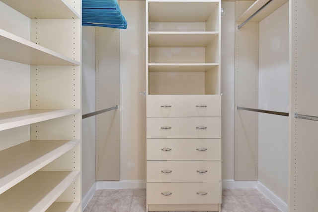 spacious closet with light tile patterned floors