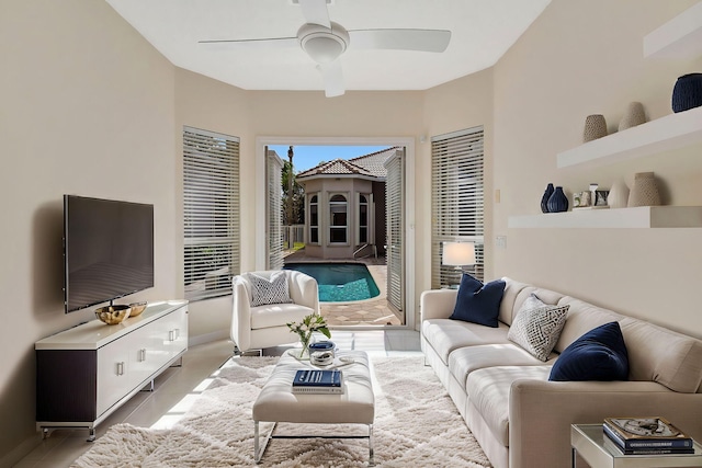 living room featuring light tile patterned flooring and ceiling fan