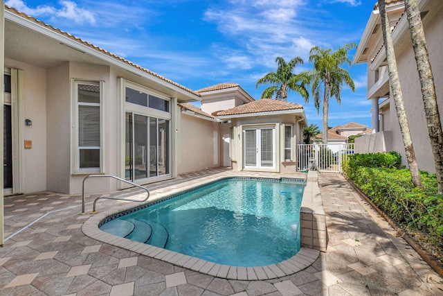 view of pool featuring a patio area and french doors