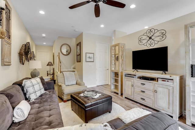 living area with recessed lighting, a ceiling fan, baseboards, stairway, and light wood finished floors