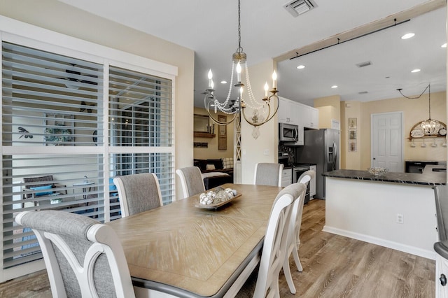 dining room featuring light wood-style floors, visible vents, a chandelier, and recessed lighting