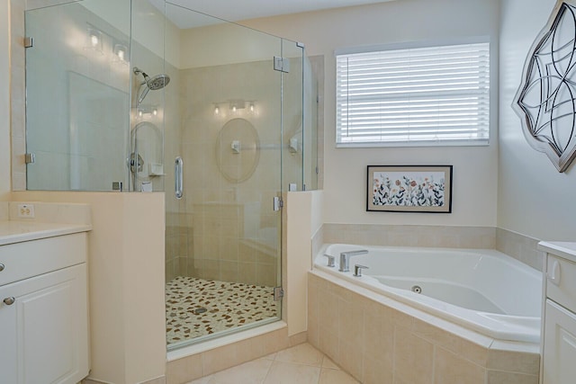 bathroom featuring tile patterned floors, a garden tub, vanity, and a shower stall