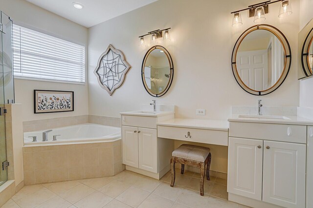 full bathroom with a garden tub, two vanities, a sink, a shower stall, and tile patterned flooring