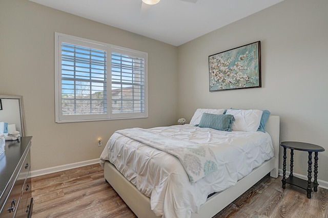 bedroom with baseboards and wood finished floors