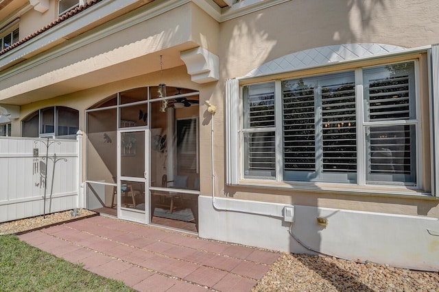 doorway to property featuring stucco siding