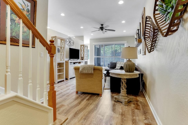 living area with light wood-style floors, baseboards, stairway, and recessed lighting