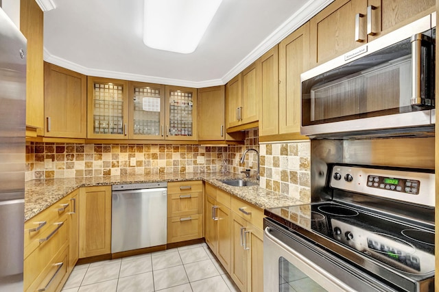 kitchen featuring light tile patterned flooring, sink, decorative backsplash, stainless steel appliances, and light stone countertops