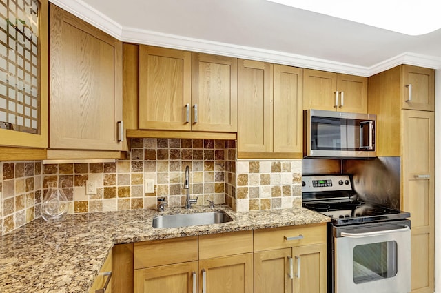 kitchen featuring sink, crown molding, backsplash, stainless steel appliances, and light stone countertops