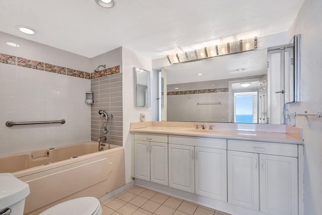 full bathroom featuring tile patterned flooring, vanity, tiled shower / bath combo, and toilet