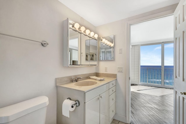 bathroom with a water view, vanity, toilet, and wood-type flooring