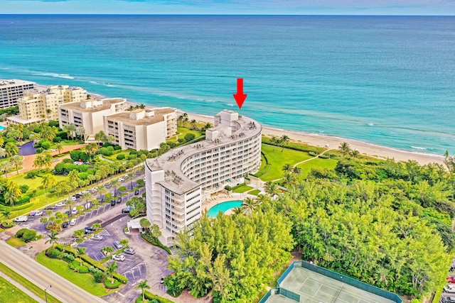 bird's eye view featuring a water view and a beach view