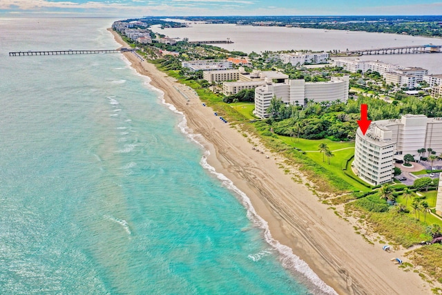 birds eye view of property featuring a water view and a view of the beach