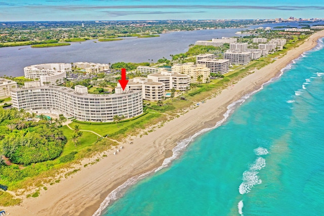 aerial view with a water view and a beach view