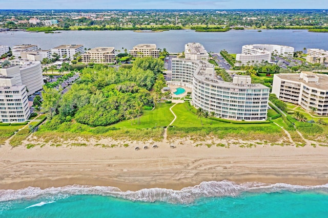 bird's eye view featuring a water view and a beach view