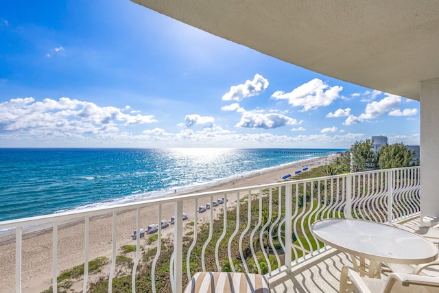 balcony with a water view and a beach view