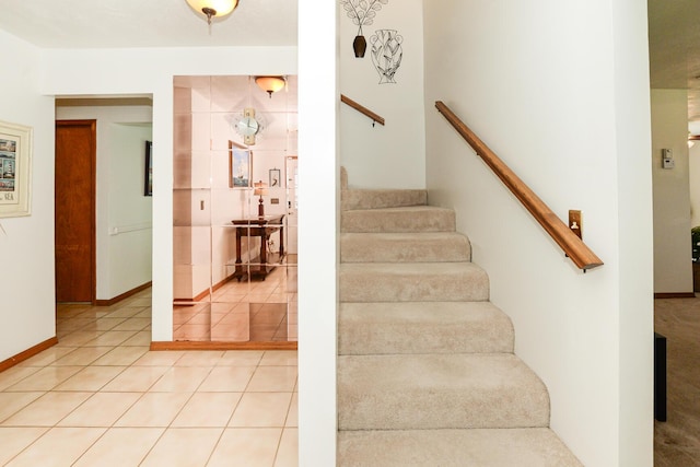 staircase featuring tile patterned flooring and baseboards