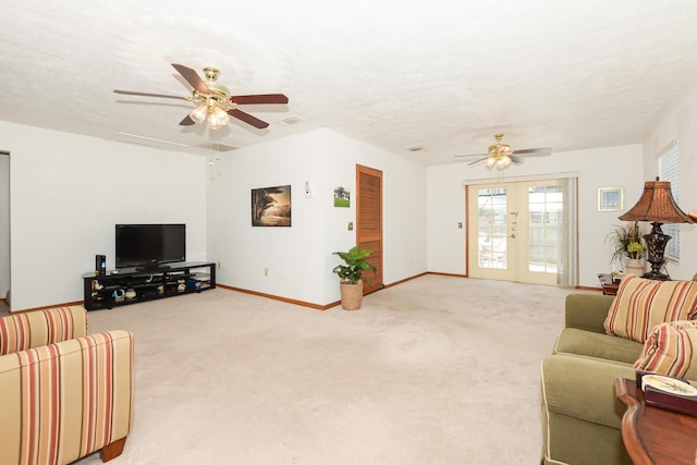living area with ceiling fan, french doors, light colored carpet, and baseboards